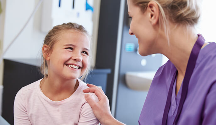 Doctor laughing with young girl