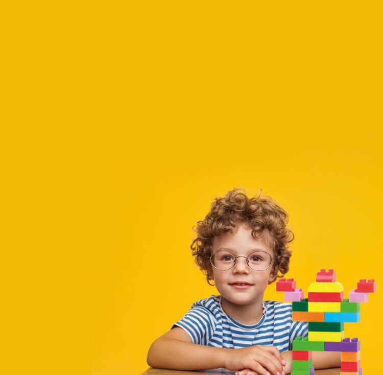 Boy with glasses and bricks