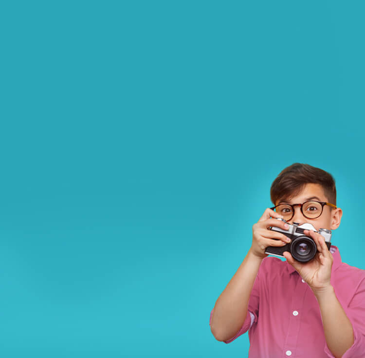 Boy taking photo with old camera